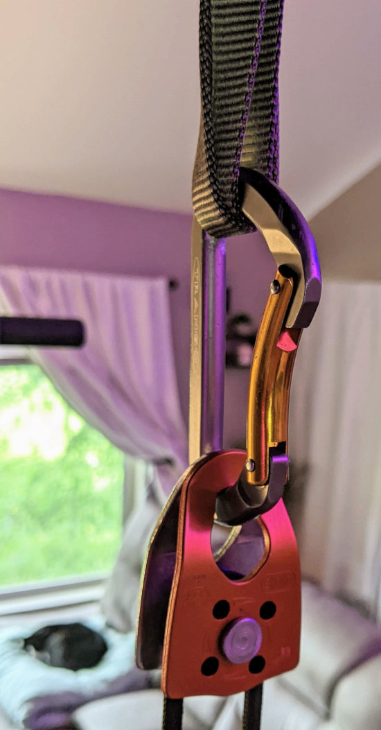 Pulley hanging off carabiner attached to a nylon loop